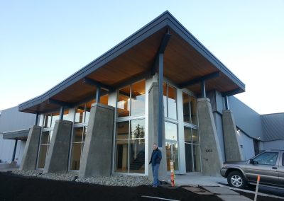 Timber and steel canopy over tapered concrete columns