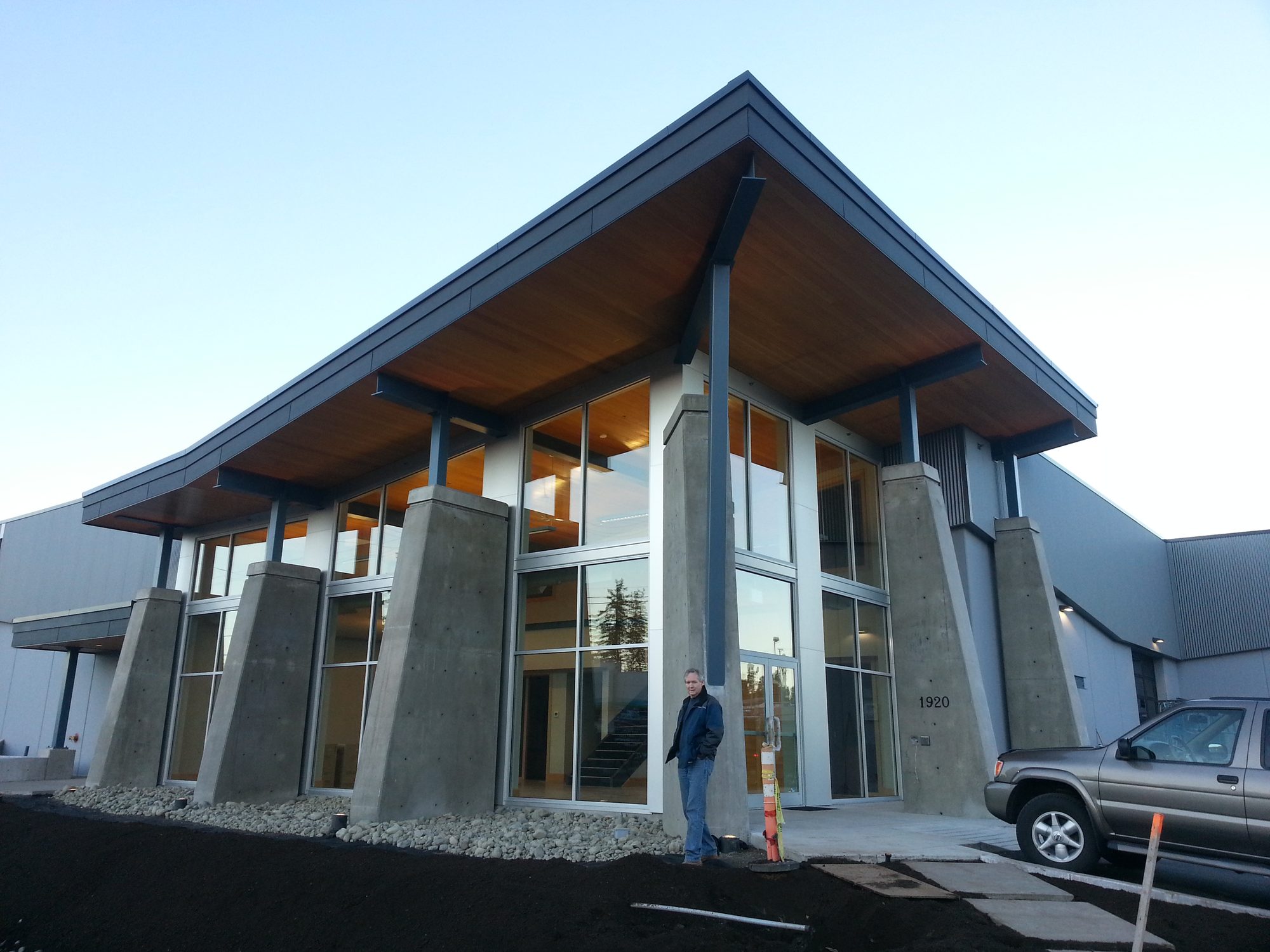 Timber and steel canopy over tapered concrete columns