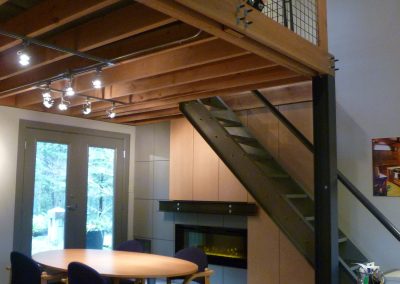 Timber-framed room with a stair and fireplace