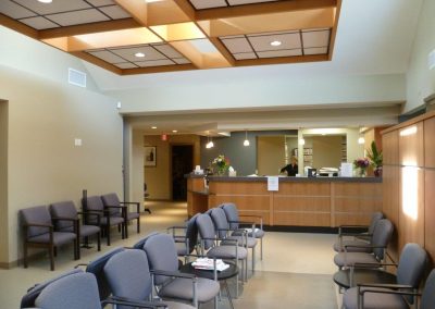 Clinic waiting room with a wood reception counter