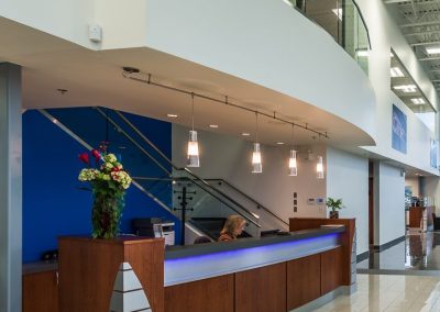 Showroom reception desk in front of a blue wall