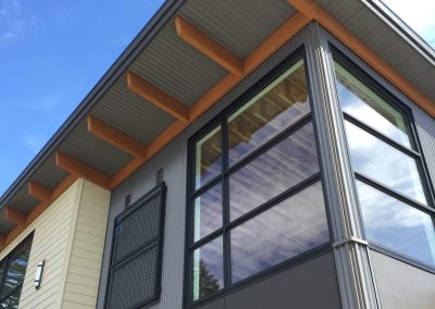 Building corner with tall glazing and a timber soffit