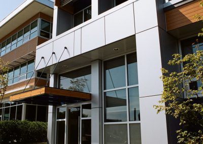 Multi-storey building with balconies and metal cladding