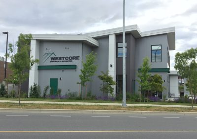 Grey office building with green signage