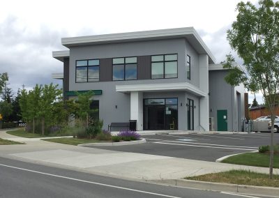 Two-storey grey commercial building at a street corner