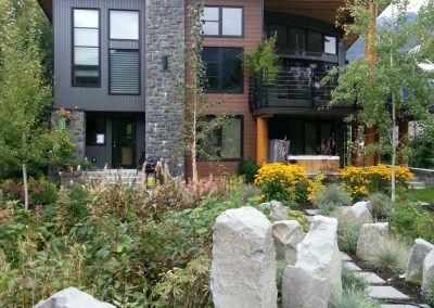 House with a stone chimney and boulders