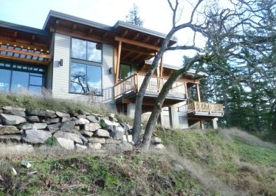 Hillside house above stone walls