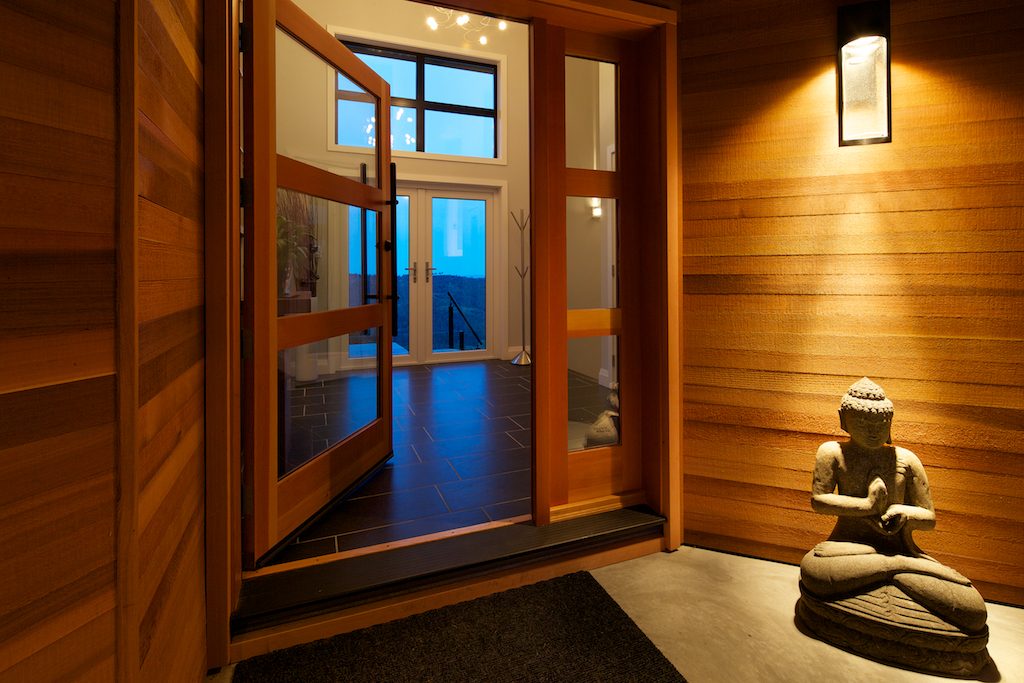Wood-panelled entry with a glass front door