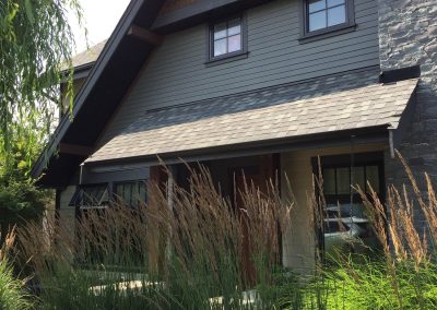 Shingled house behind tall grasses