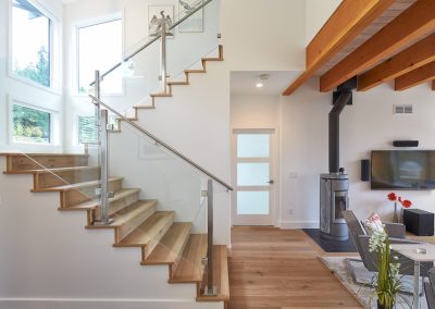 Open staircase and living area with a wood stove