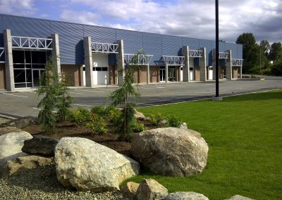 Industrial units behind landscaped boulders