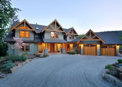 Large house with timber gables and a paved drive