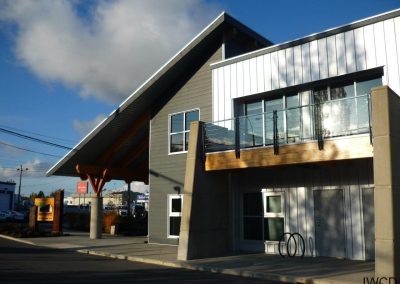 Metal-clad building with a timber canopy