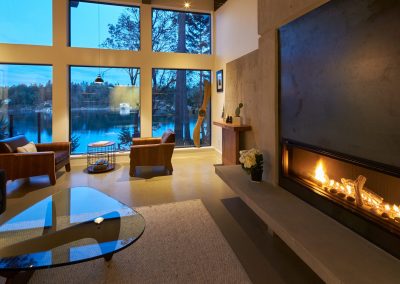Living room with a fireplace and water view